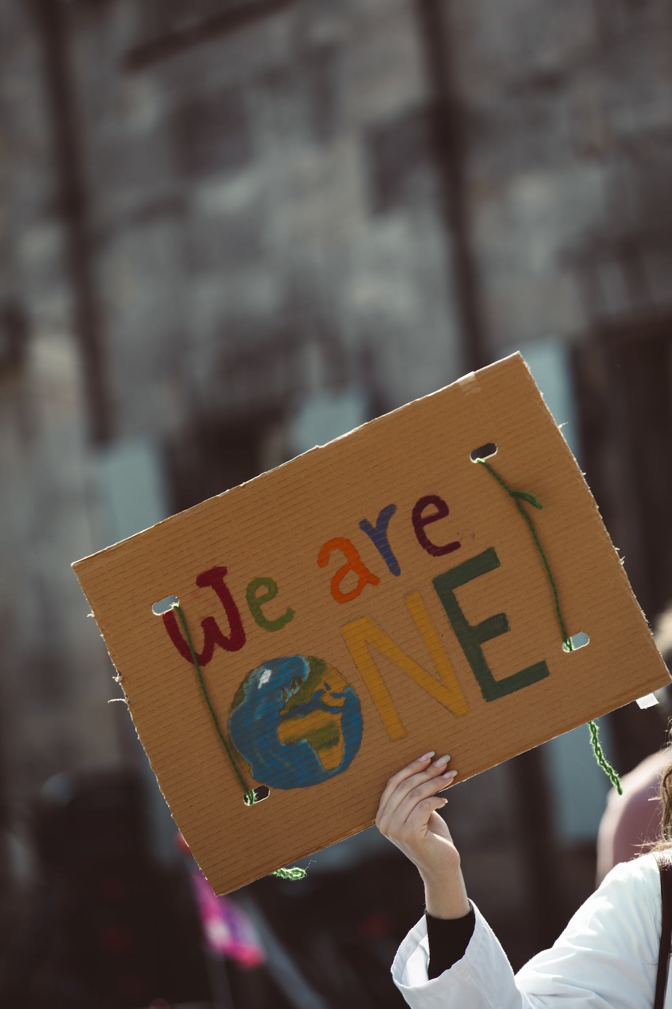 Hand Holding a Cardboard with Message 